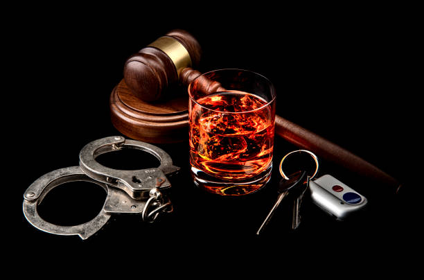 A conceptual image featuring a glass of whiskey, handcuffs, a judge's gavel, and car keys, representing the legal consequences of a DUI charge in Arizona, ideal for content addressing DUI laws and penalties.