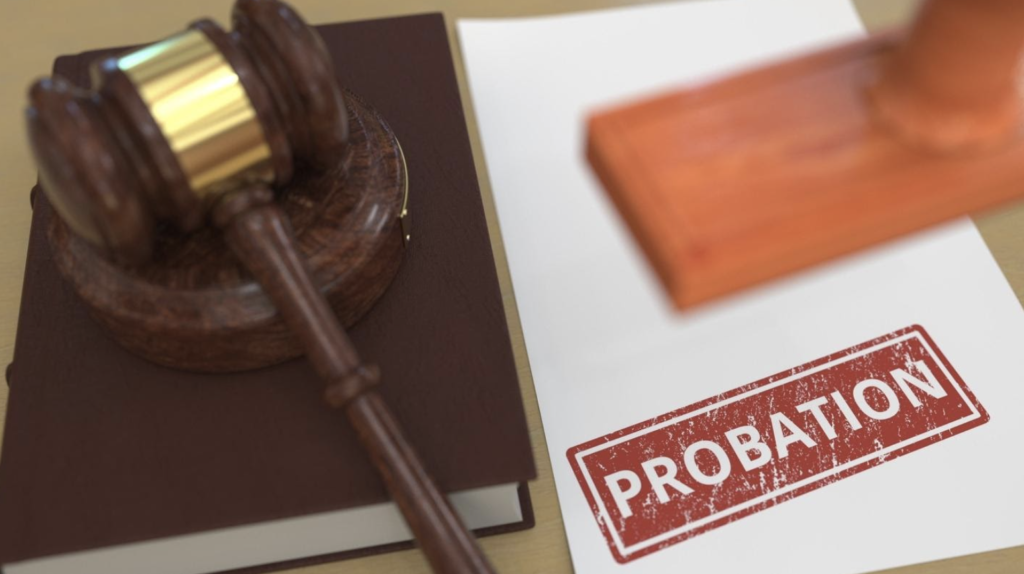 Judicial gavel on a brown book with a 'PROBATION' stamp on a paper beside it, representing the concept of probation violation in the state of Arizona.