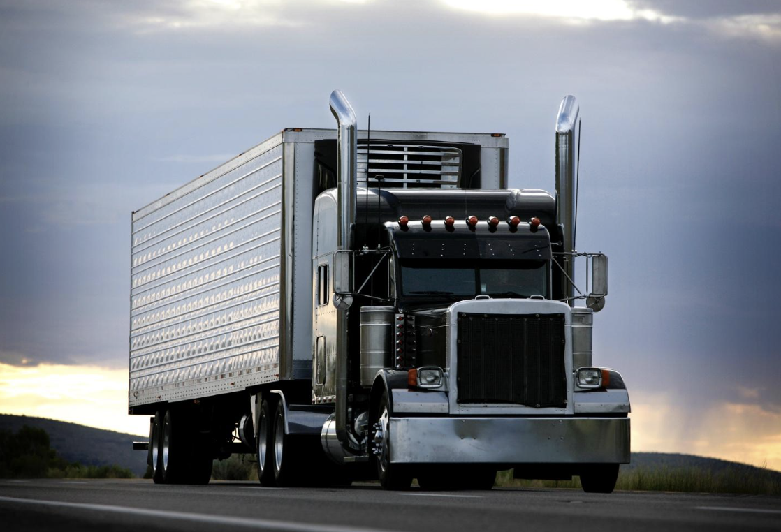 Front view of a large commercial truck on the highway, representing the trucking industry and related driver regulations
